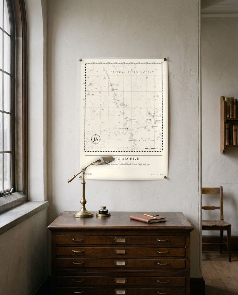 A chart print of the Central Pacific hanging above a wooden map cabinet